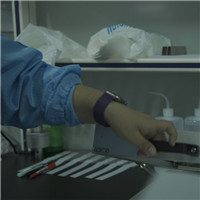 Closeup of hand operating PPF thickness measurement device