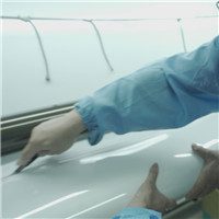 Technician monitoring self-healing test on PPF surface