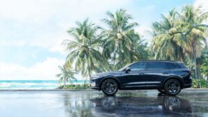 Luxury SUV parked on tropical coastal road in humid climate, pristine paint surface protected by PPF