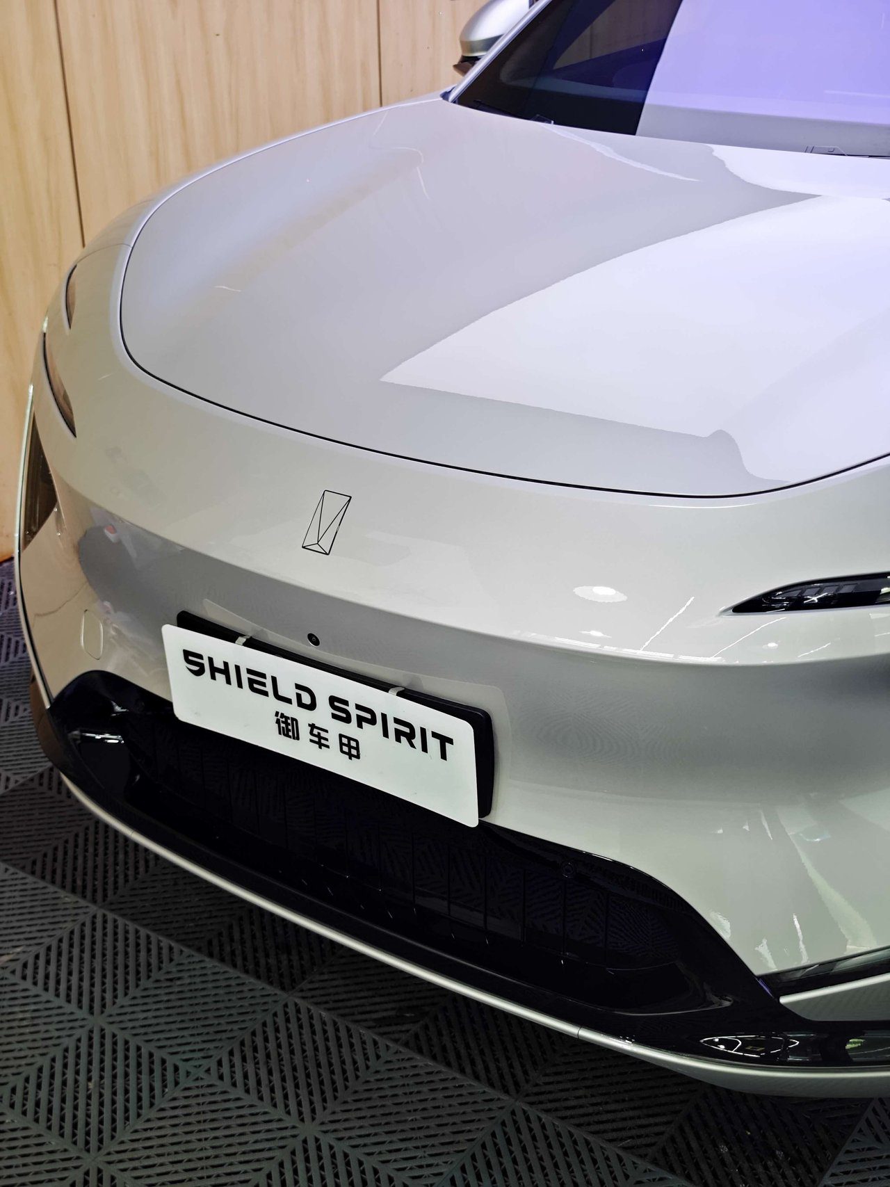 Close-up view of electric SUV rear with freshly applied transparent paint protection film showing high-gloss finish