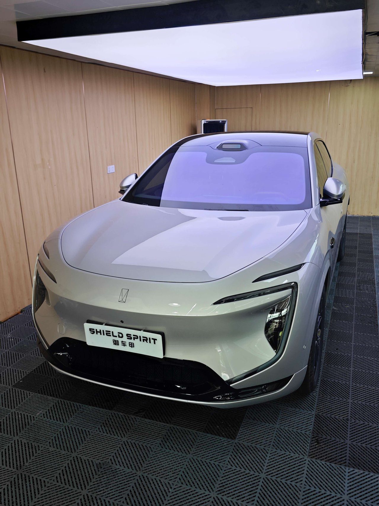 Electric SUV positioned in dust-controlled installation bay with professional lighting for PPF application