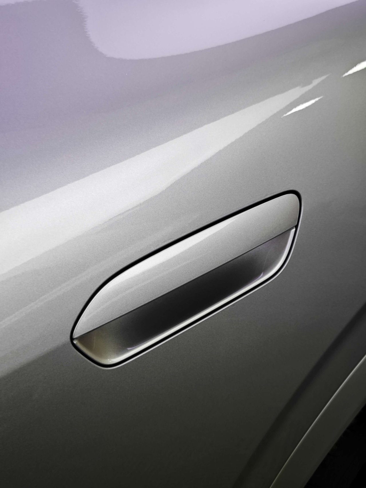 Detail view of door handle area wrapped in paint protection film showing precise edge tucking technique