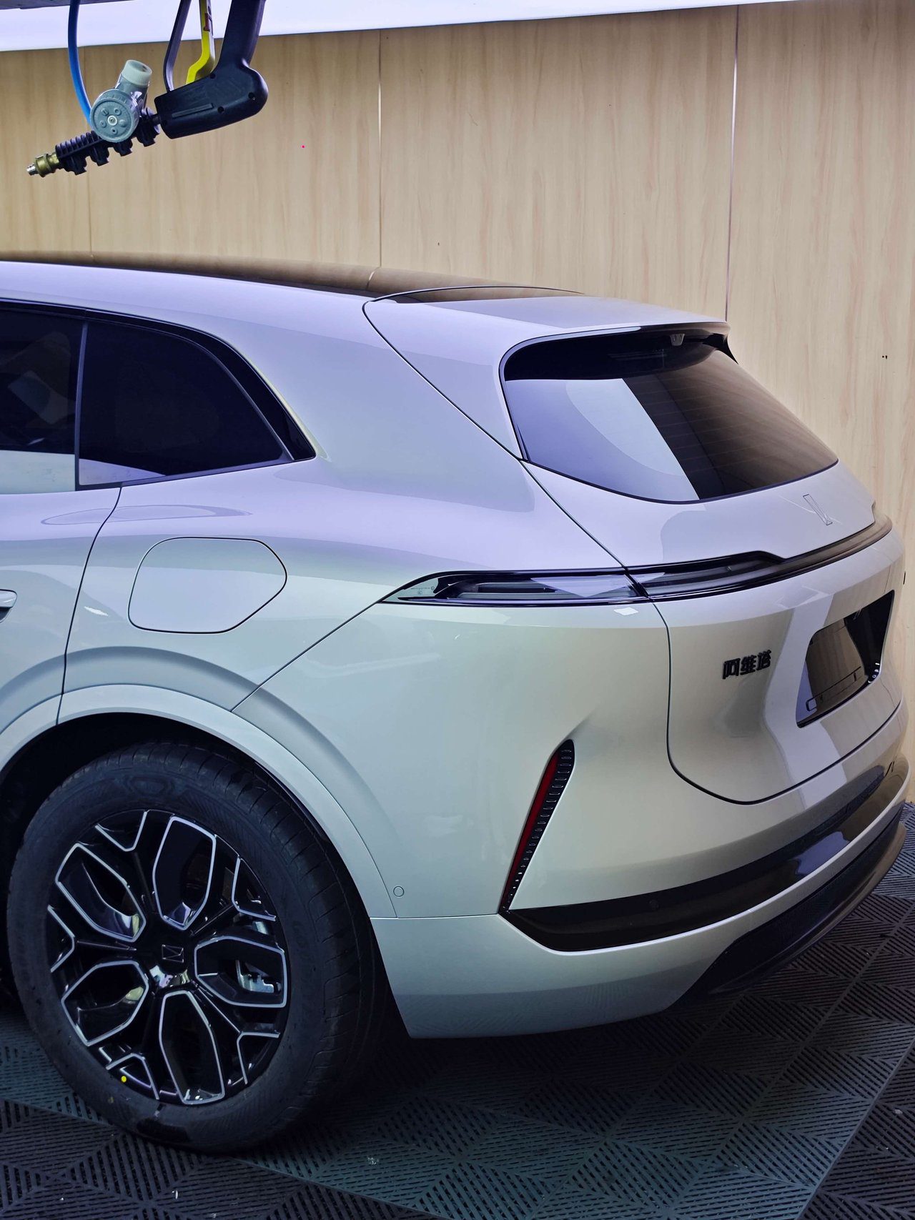 Rear quarter panel and taillight area showing seamless PPF installation on electric SUV