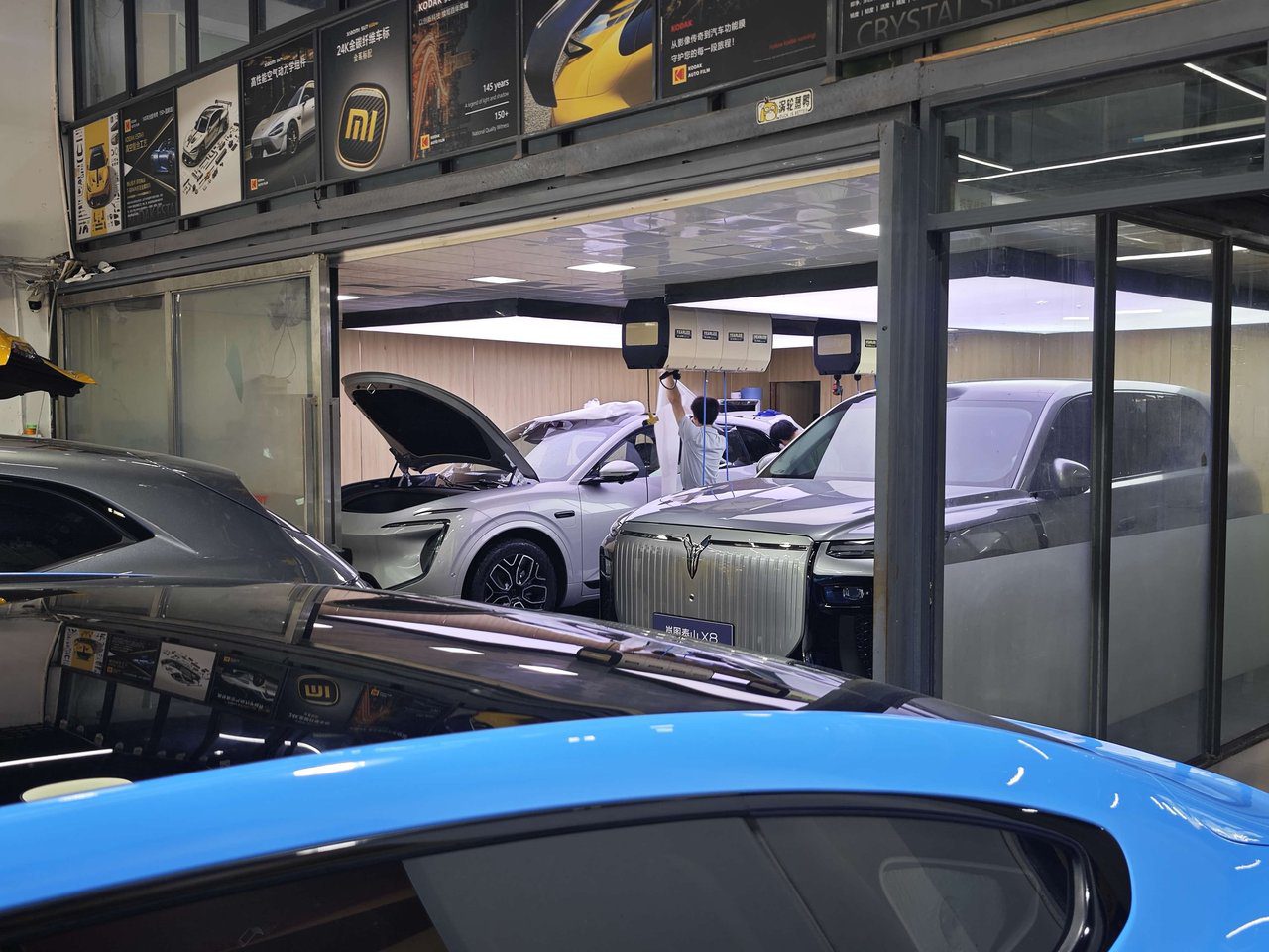 YuCheJia Foshan flagship store with luxury vehicles waiting for paint protection film installation