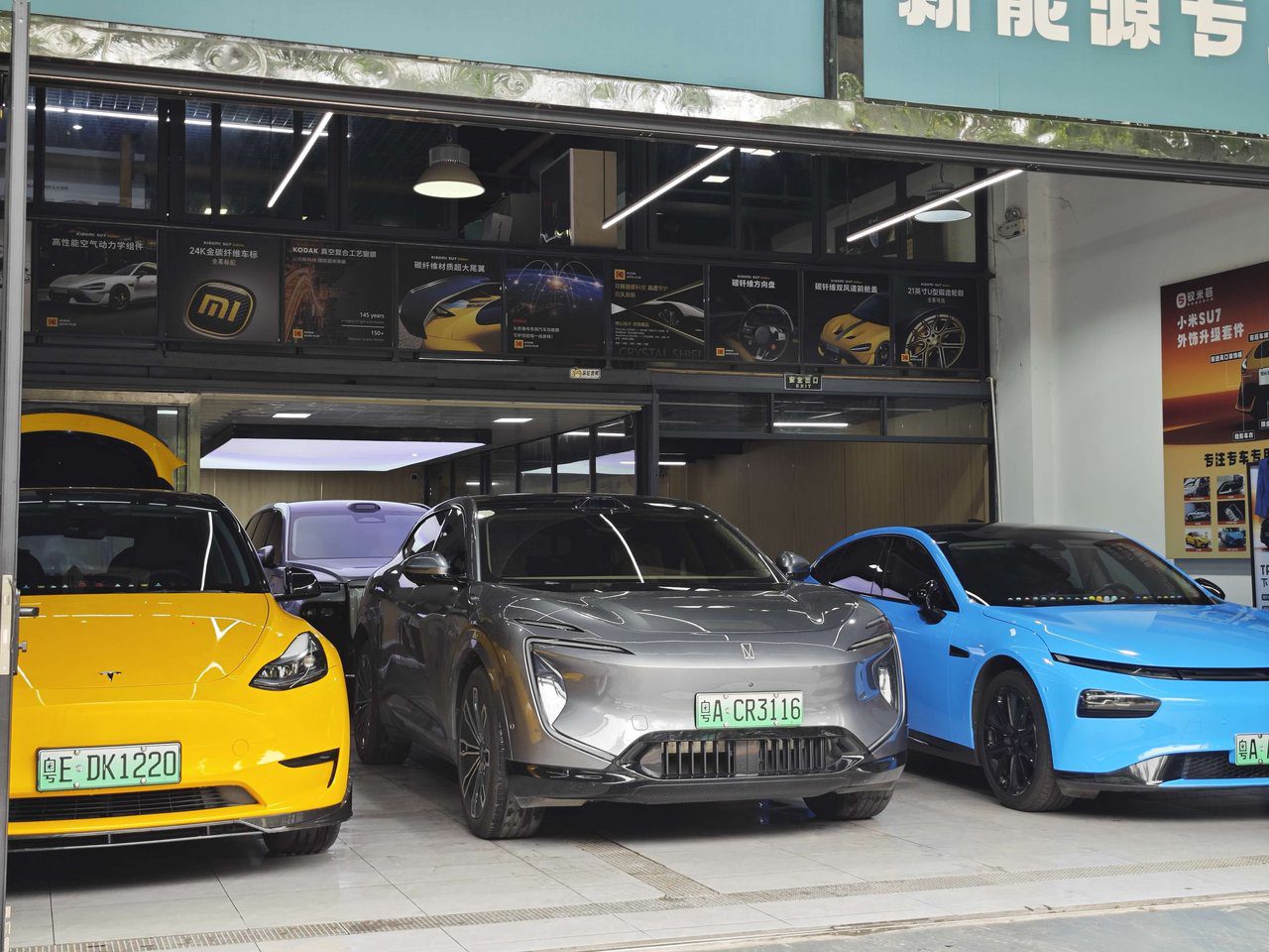 High-end vehicles queued for paint protection film service at the YuCheJia Foshan flagship store